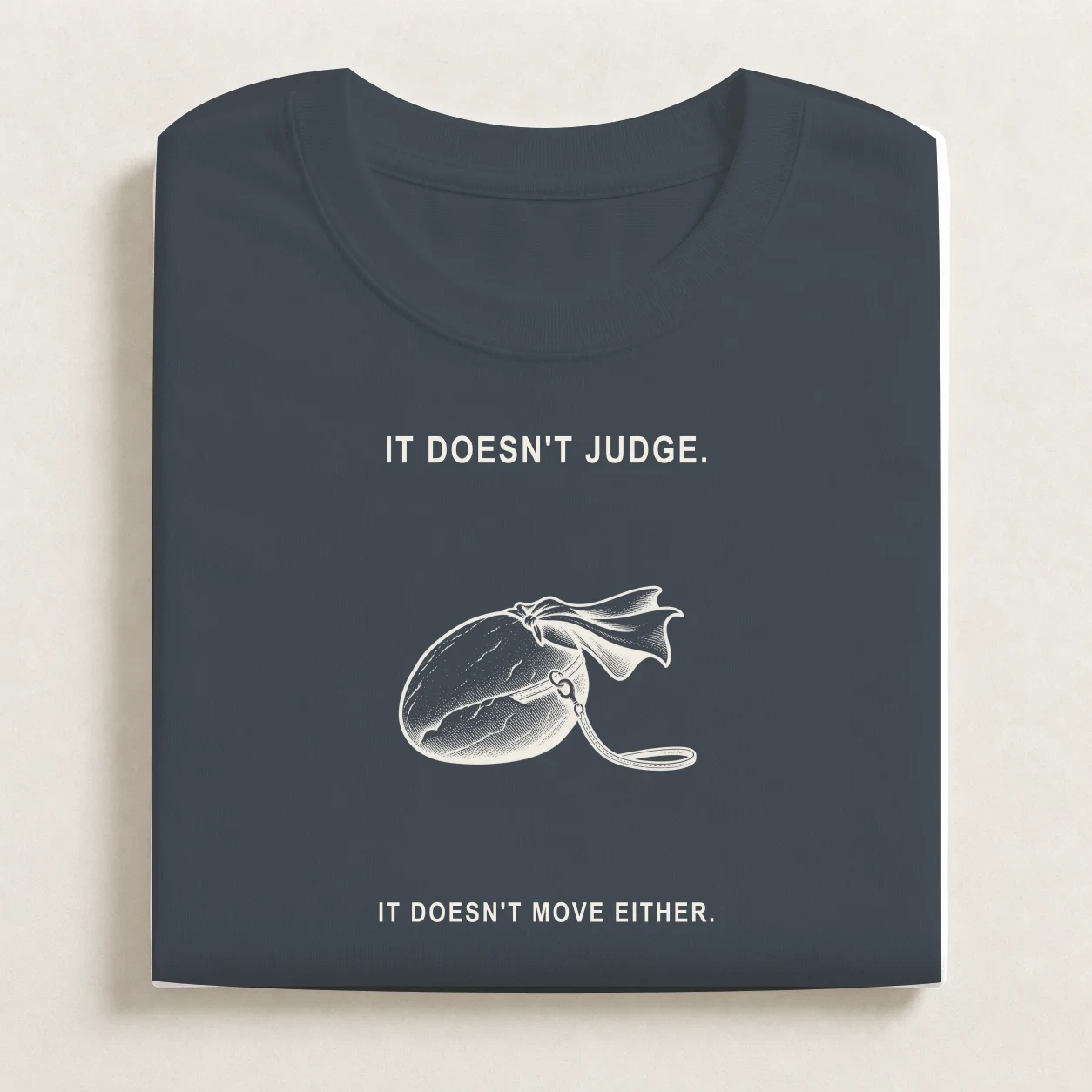 Emotional Support Rock printed on a folded Petrol Blue T-shirt.